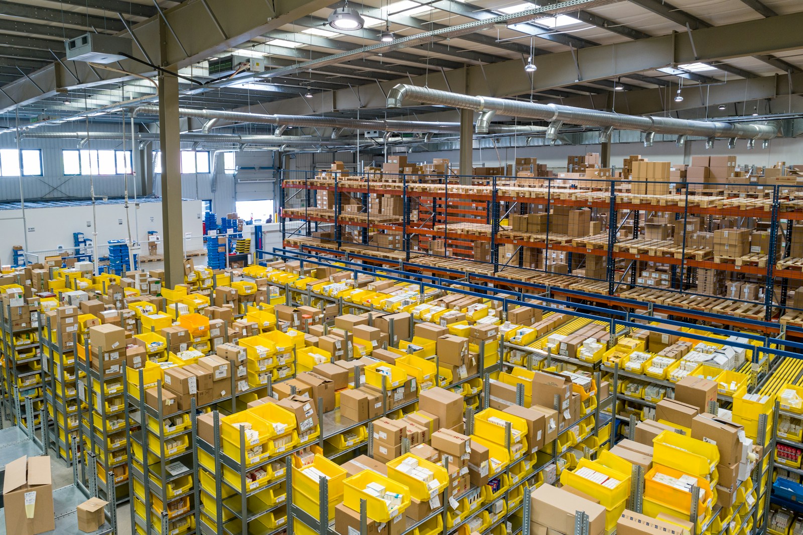 Autonomous mobile robot navigating a warehouse aisle during fleet design session